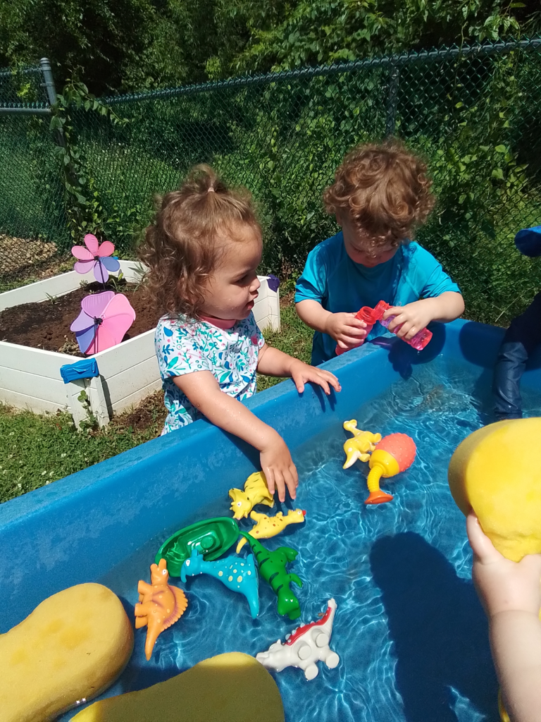 Toddlers play in water table